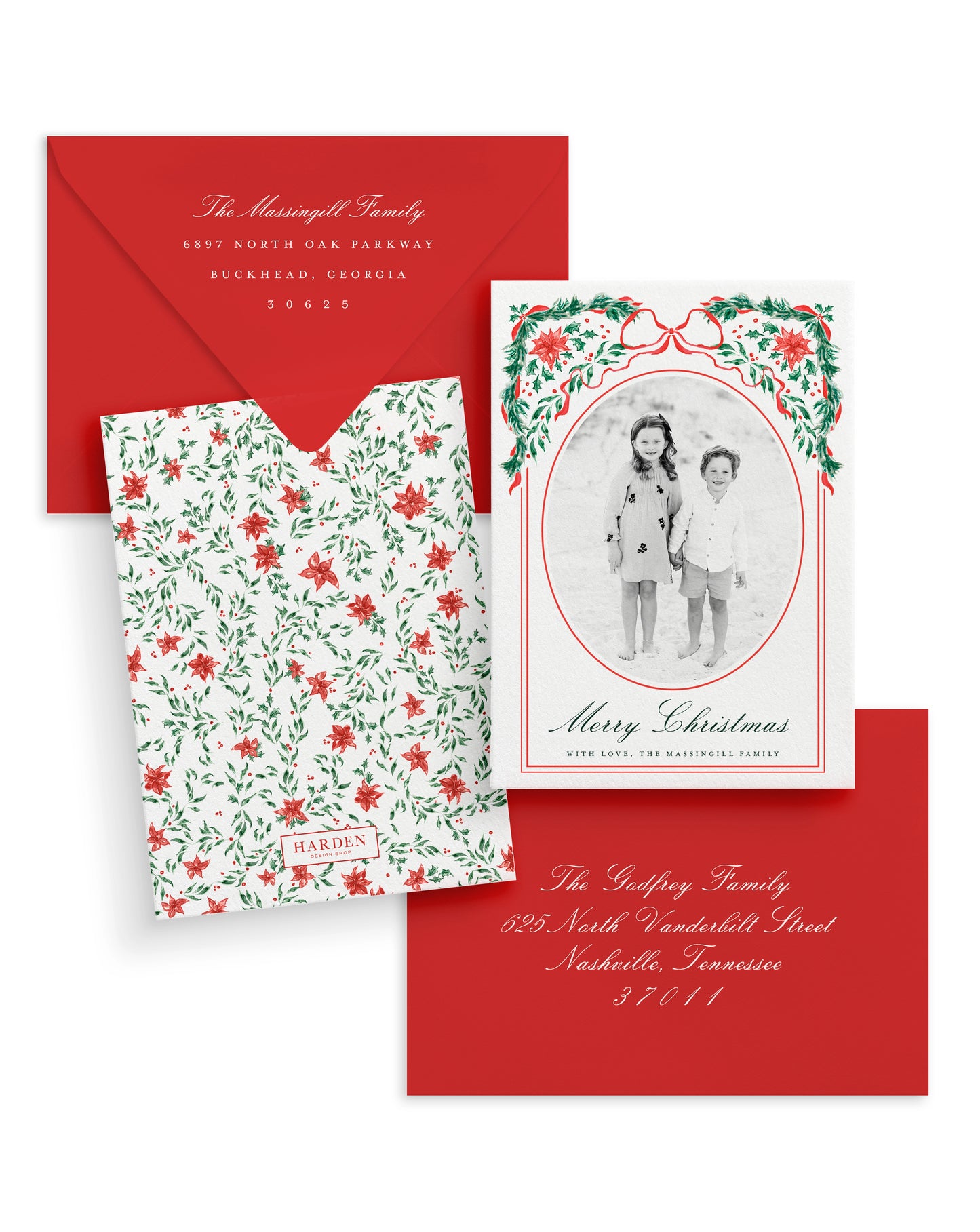 Christmas card set with floral design, photo of two children, and red envelope.
