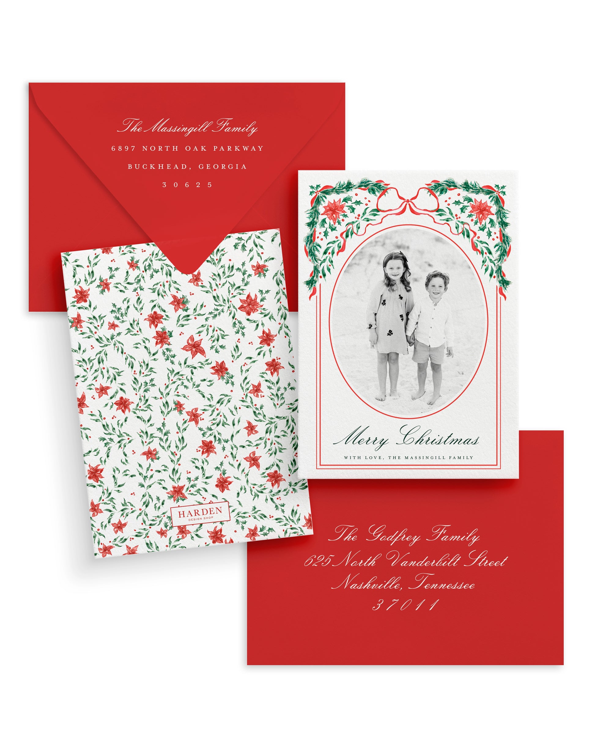 Christmas card set with floral design, photo of two children, and red envelope.