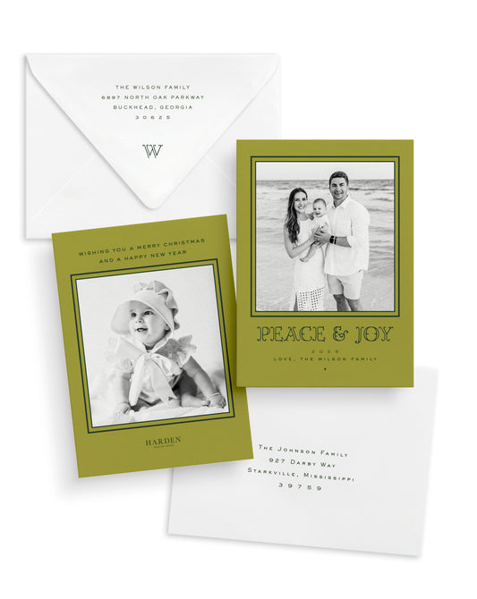 Christmas cards with black and white photos and a chartreuse border and envelopes on a white background